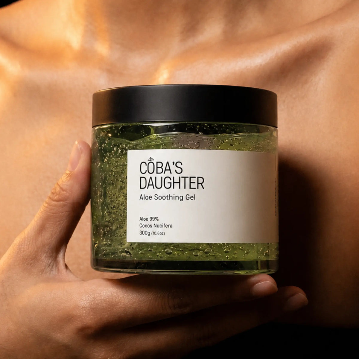 Jar of CoBa's Daughter Aloe Soothing Gel held in a hand against a skin-toned background