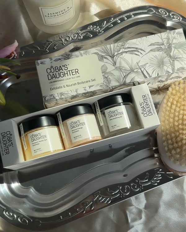 CoBa's Daughter Exfoliate and Nourish 3-Piece Body Care Gift Set opened box revealing Turmeric Honey, Almond Orange scrubs and Aloe Gel