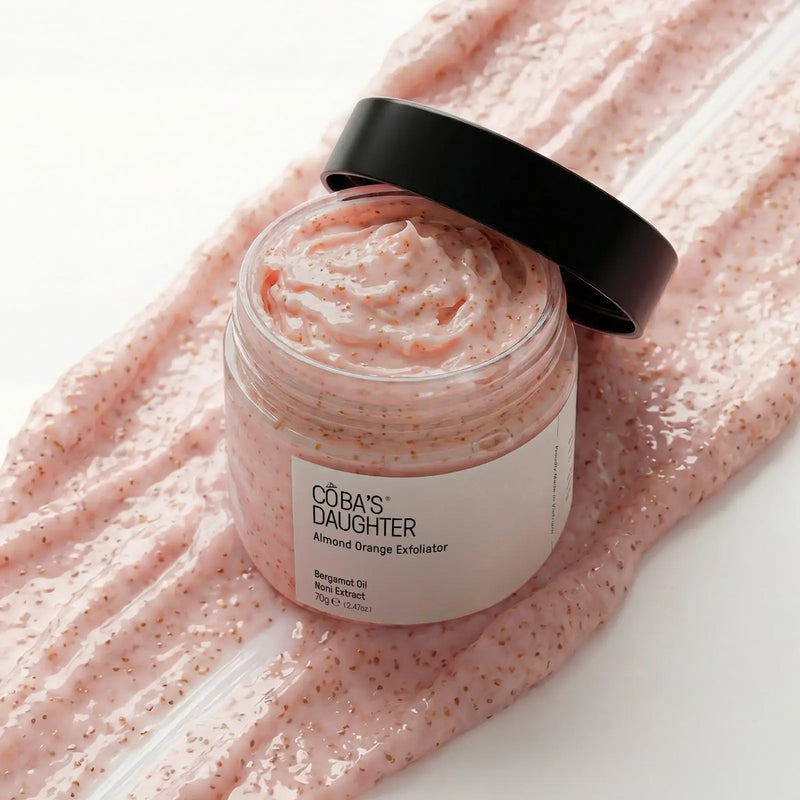 CoBa's Daughter Almond Orange Exfoliator open jar showing smooth creamy pink scrub texture with bergamot oil and noni extract