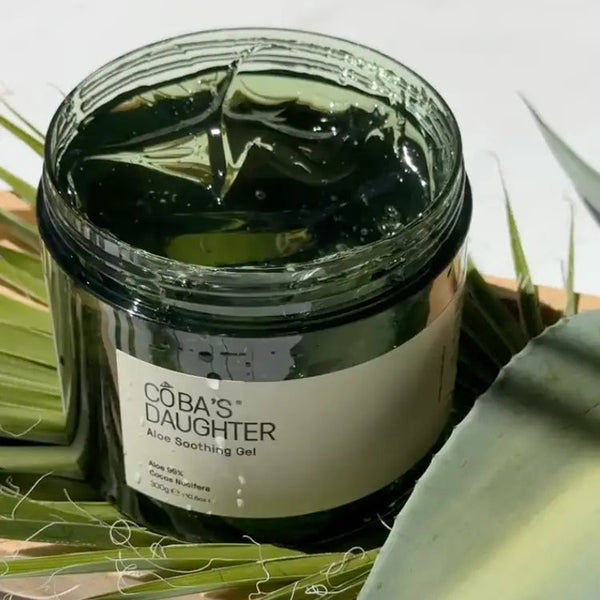 CoBa's Daughter Aloe Soothing Gel jar with fresh aloe vera leaves — 99% pure aloe gel for sunburn relief and hydration