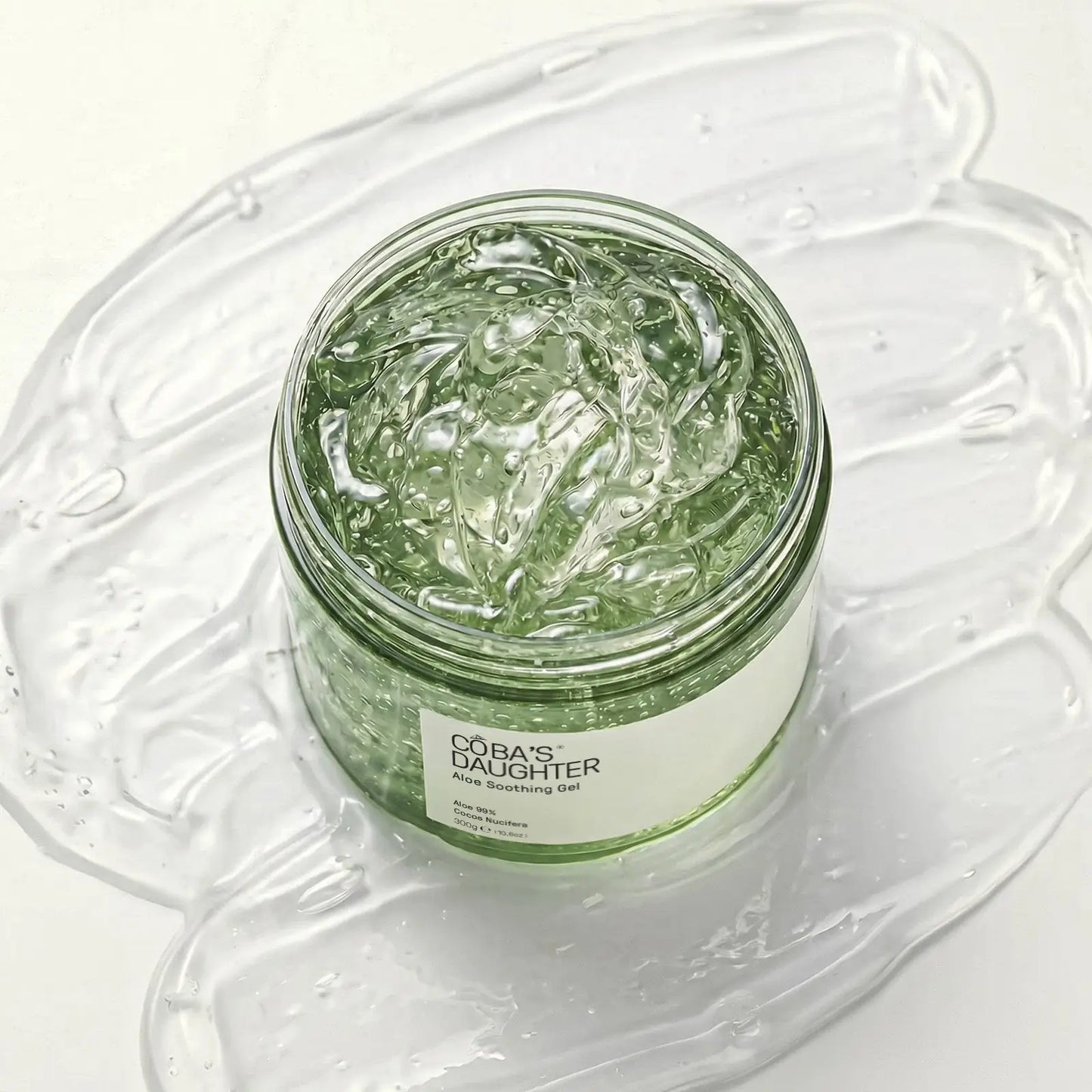 CoBa's Daughter 99% Pure Aloe Soothing Gel open jar close-up showing clear translucent texture in open jar with coconut oil and vitamin E