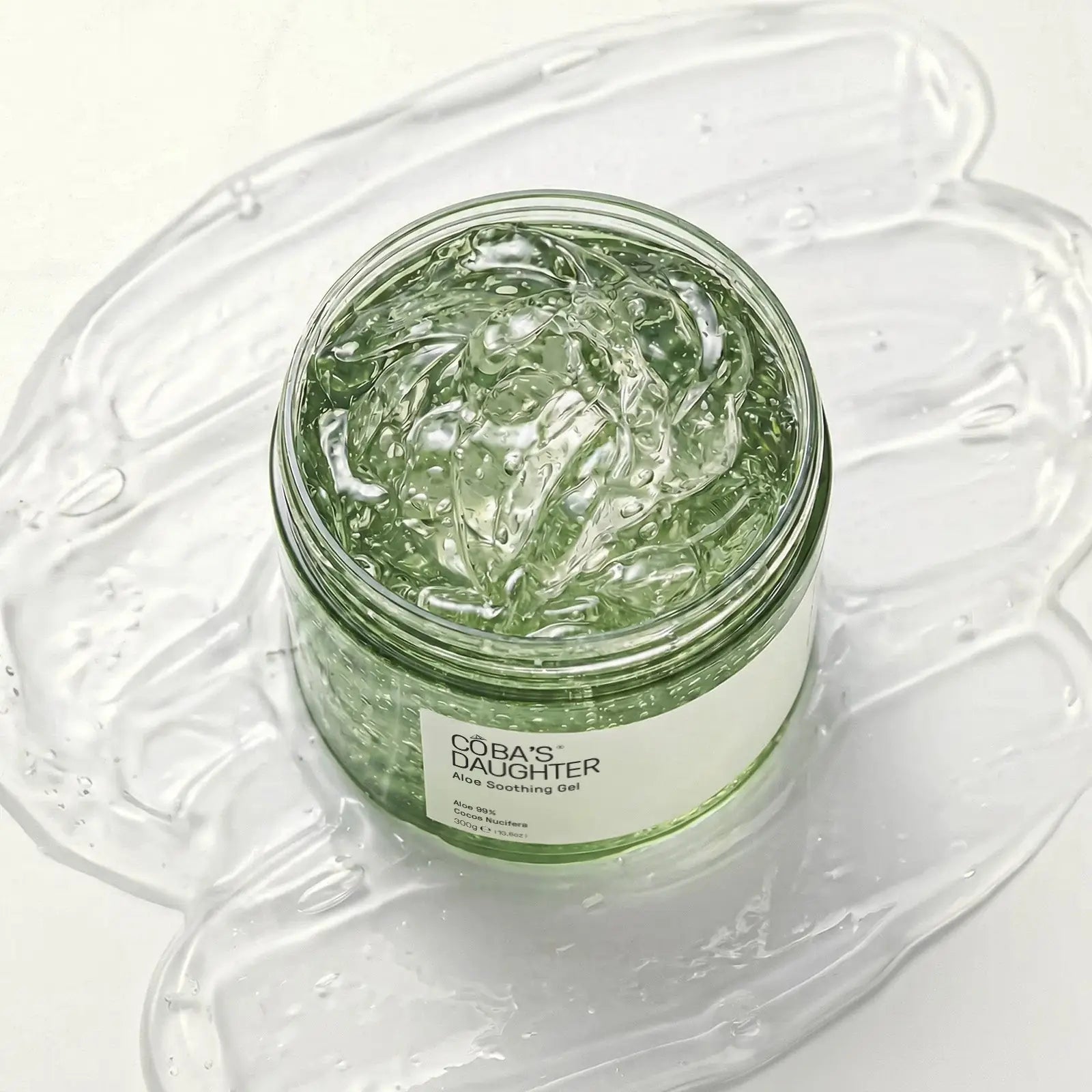 CoBa's Daughter 99% Pure Aloe Soothing Gel open jar close-up showing clear translucent texture in open jar with coconut oil and vitamin E