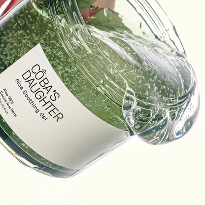 CoBa's Daughter 99% Pure Aloe Soothing Gel pouring with clear translucent texture in wide-mouth jar with brand label visible