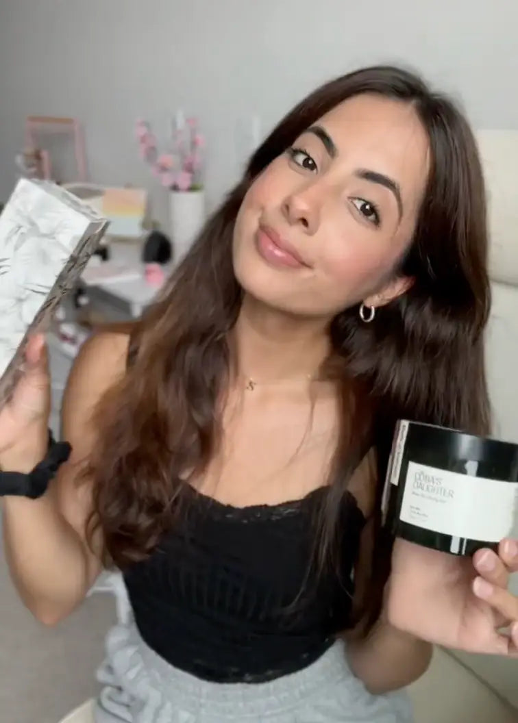 Woman holding CoBa's Daughter 99% Pure Aloe Soothing Gel jar with product packaging for skincare review