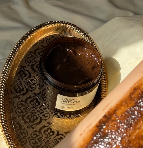 CoBa's Daughter Robusta Coffee Body Scrub open jar showing dark brown texture with coffee grounds on decorative golden tray