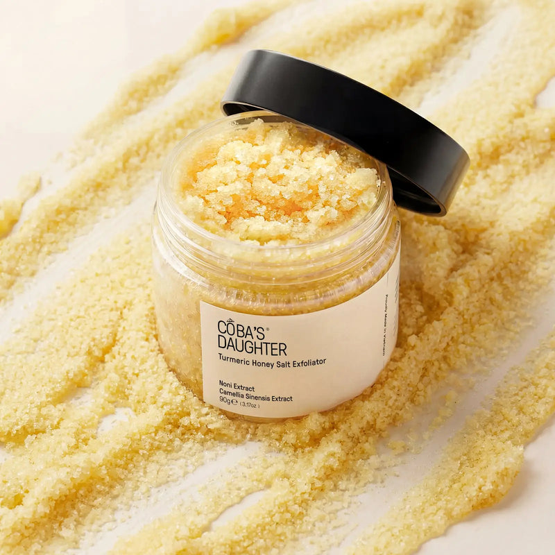 CoBa's Daughter Turmeric Honey Salt Exfoliator open jar showing golden coarse salt crystals and noni extract 