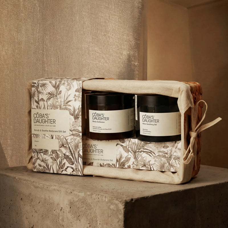 CoBa's Daughter gift set with two scrub and soothe body care products in a decorative box on a textured surface.